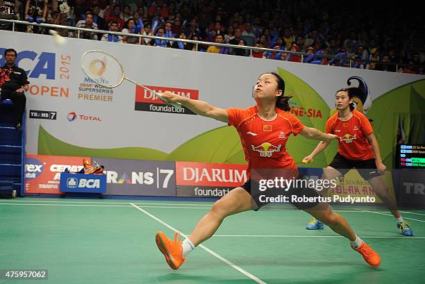 Ma Jin and Tang Yuanting of China returns a shot against Lee So Hee and Shin Seung Chan of Korea during the 2015 BCA Indonesia Open Quarterfinals...