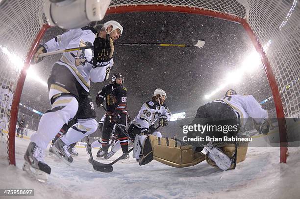 Goaltender Marc-Andre Fleury of the Pittsburgh Penguins makes a save as Patrick Kane of the Chicago Blackhawks and Rob Scuderi and Joe Vitale of the...