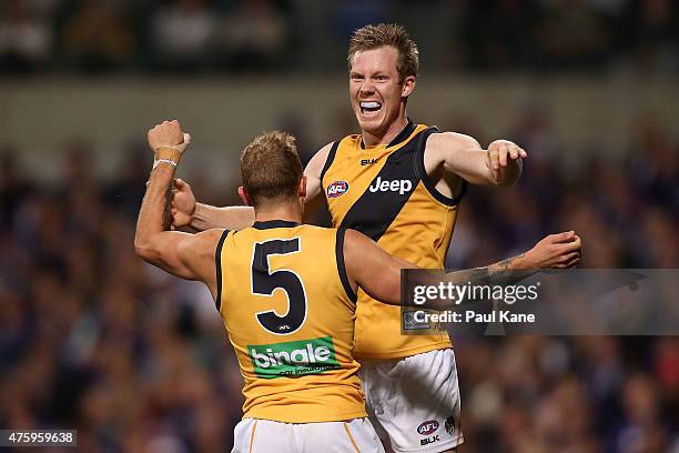 Brandon Ellis and Jack Riewoldt of the Tigers celebrate a goal during the round 10 AFL match between the Fremantle Dockers and the Richmond Tigers at...