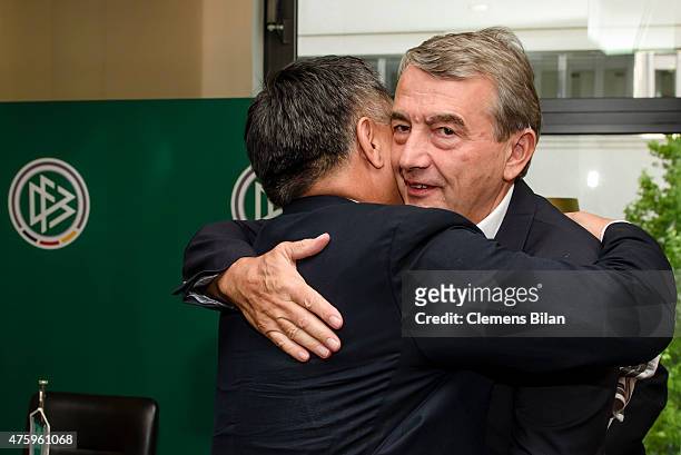Wolfgang Niersbach and Kohzo Tashima embrace each other after signing a memorandum of understanding with Japan Football Association at the Marriott...