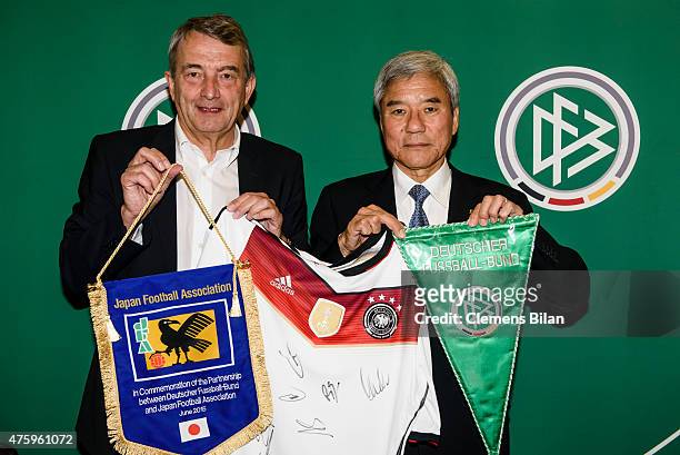 Wolfgang Niersbach and Kuniya Daini pose after signing a memorandum of understanding with Japan Football Association at the Marriott Hotel on June 5,...