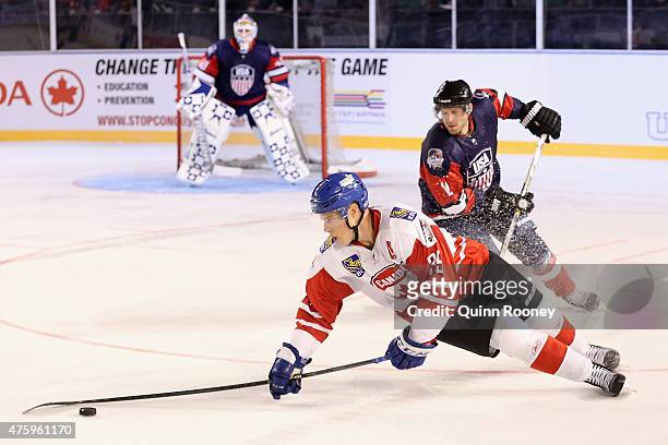 Frazer McLaren of Canada dives for the puck during the 2015 Ice Hockey Classic match between the United States of America and Canada at Rod Laver...
