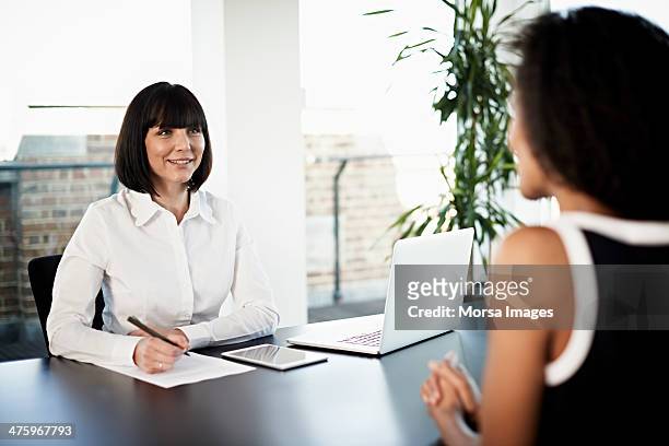 businesswoman conducting an interview - candidato foto e immagini stock