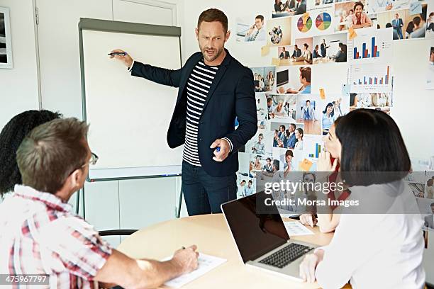 creative businessman presenting project - man flipchart stock pictures, royalty-free photos & images
