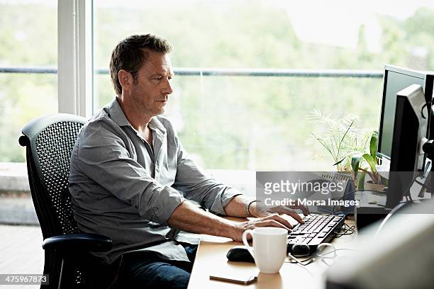 business man working on computer - desktop pc stock pictures, royalty-free photos & images