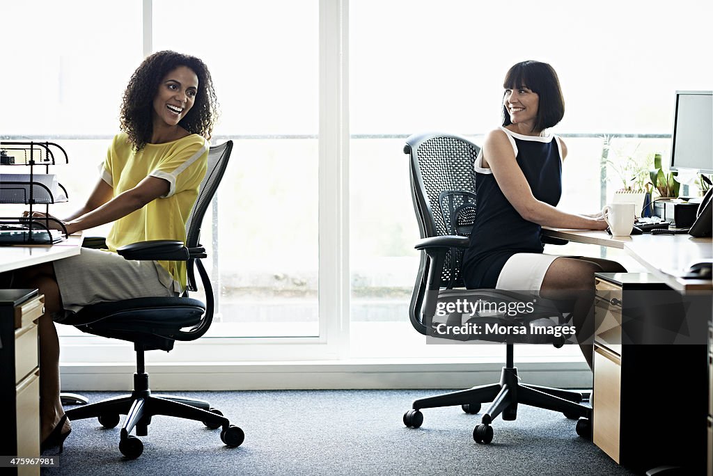 Female coworkers laughing