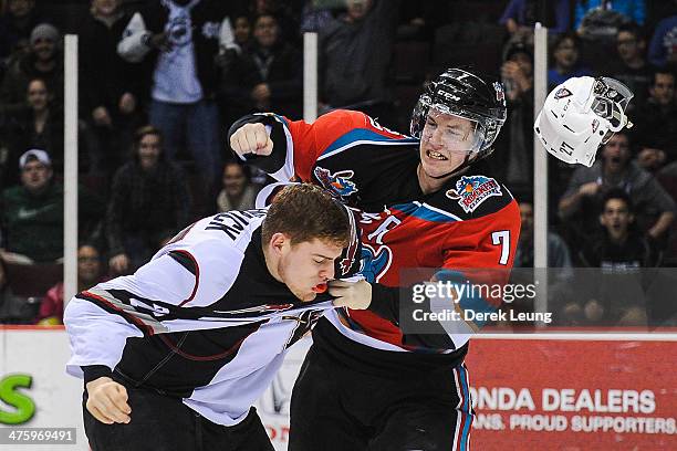 Jackson Houck of the Vancouver Giants loses his helmet after being punched by Damon Severson of the Kelowna Rockets during a WHL game at the Pacific...