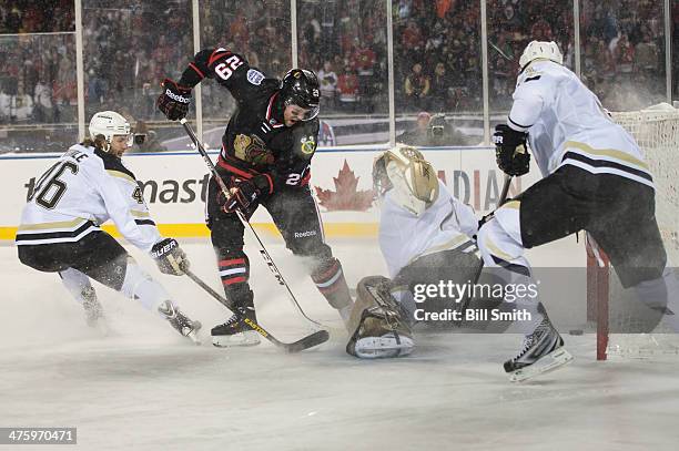 Bryan Bickell of the Chicago Blackhawks scores on goalie Marc-Andre Fleury of the Pittsburgh Penguins in the third period, as Joe Vitale of the...