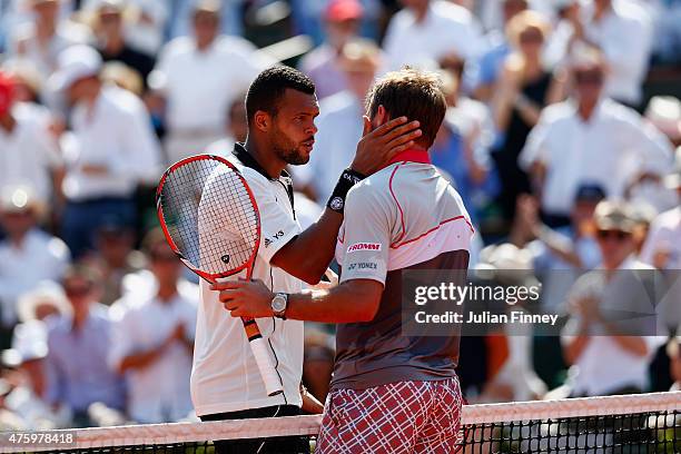 Jo-Wilfried Tsonga of France congratulates Stanislas Wawrinka of Switzerland ath the net after their Men's Semi Final match on day thirteen of the...