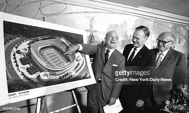 Smiling Gov. William Cahill points to drawing of stadium the Giants will inhabit in East Rutherford. Standing by are Giants President Wellington Mara...