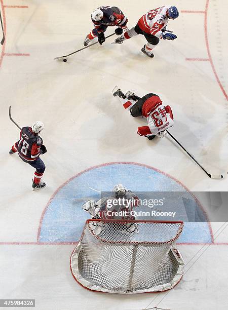 Nolan Yonkman of Canada falls to the ground after taking a puck to the head during the 2015 Ice Hockey Classic match between the United States of...