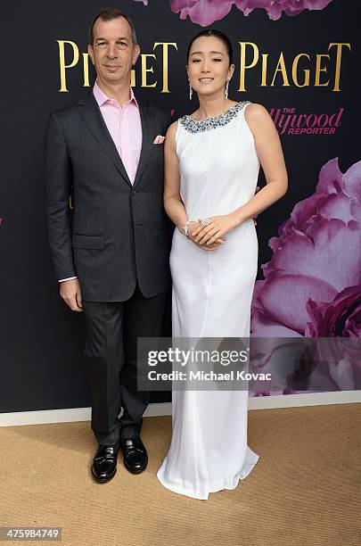 Of Piaget Philippe Leopold-Metzger and actress Li Gong, wearing Piaget, pose in the Piaget Lounge during the 2014 Film Independent Spirit Awards at...