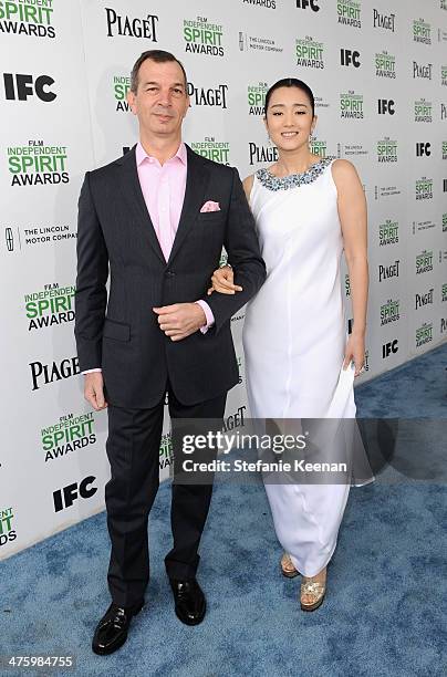 Of Piaget Philippe Leopold-Metzger and actress Li Gong, wearing Piaget, pose in the Piaget Lounge during the 2014 Film Independent Spirit Awards at...