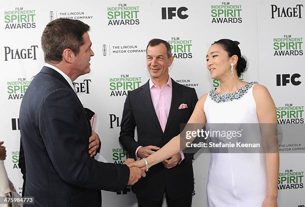 President of Film Independent Josh Welsh, CEO of Piaget Philippe Leopold-Metzger and actress Li Gong, wearing Piaget, pose in the Piaget Lounge...