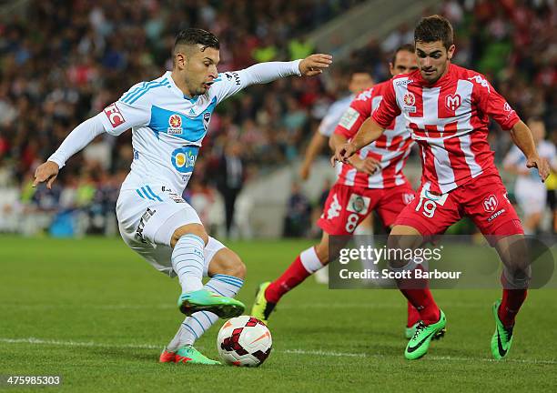Kosta Barbarouses of the Victory and Ben Garuccio of the Heart compete for the ball during the round 21 A-League match between Melbourne Heart and...