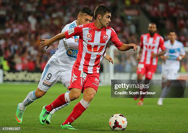 Kosta Barbarouses of the Victory and Ben Garuccio of the Heart compete for the ball during the round 21 A-League match between Melbourne Heart and...