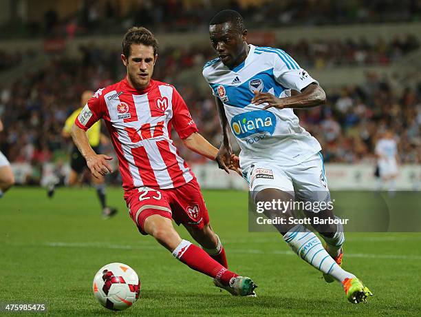 Adama Traore of the Victory and Mate Dugandzic of the Heart compete for the ball during the round 21 A-League match between Melbourne Heart and...