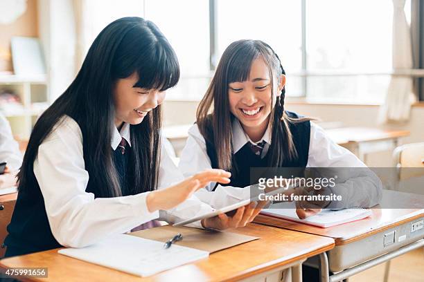 japanese school girls using digital tablet in classroom - report fun stock pictures, royalty-free photos & images