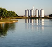 Lake with Silos in the Background