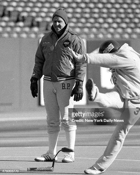 Bill Parcells watches Eric Schubert, inconsistent of late, take his kicks at giants final practice.