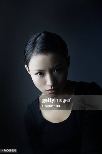 girl on the dark background - studio portrait dark background stock-fotos und bilder