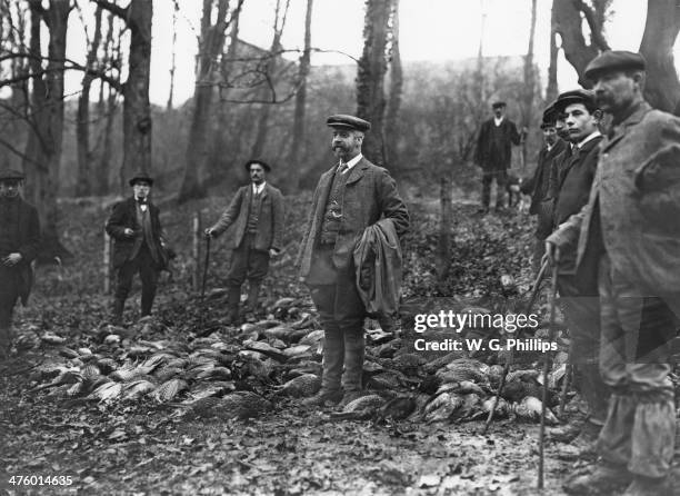 The head gamekeeper and his men with the day's kill from a pheasant shoot at Warter Priory, East Yorkshire, December 1910.