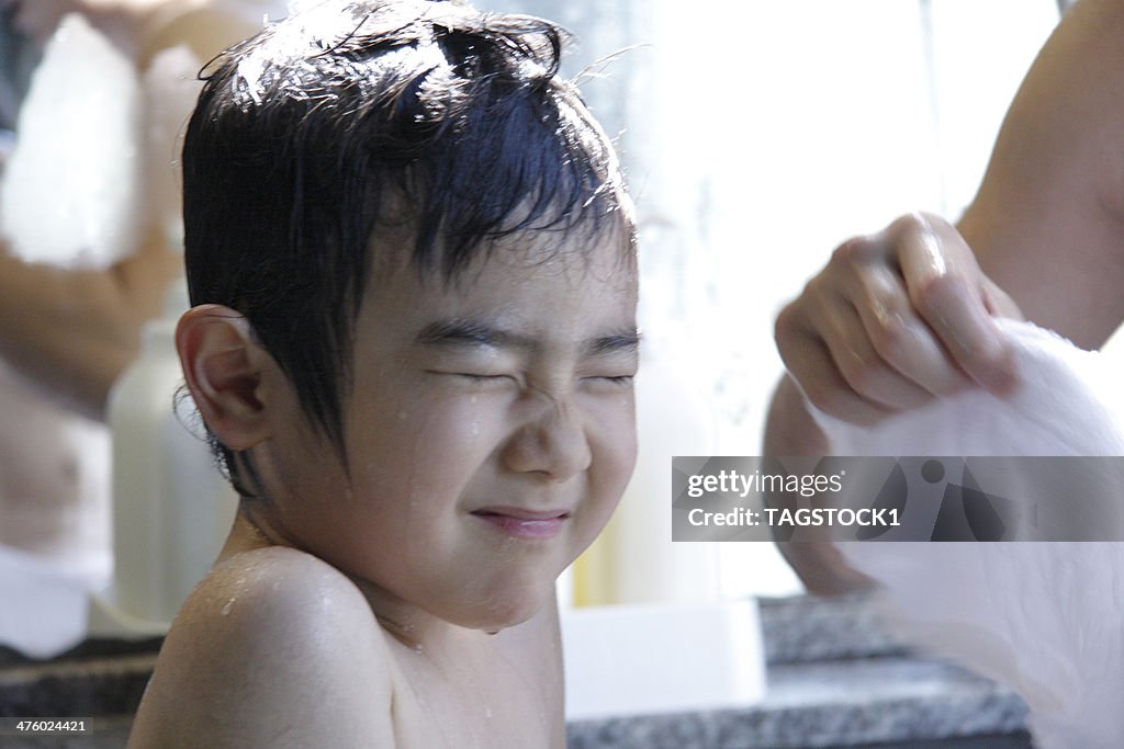 Boy having his hair shampooed
