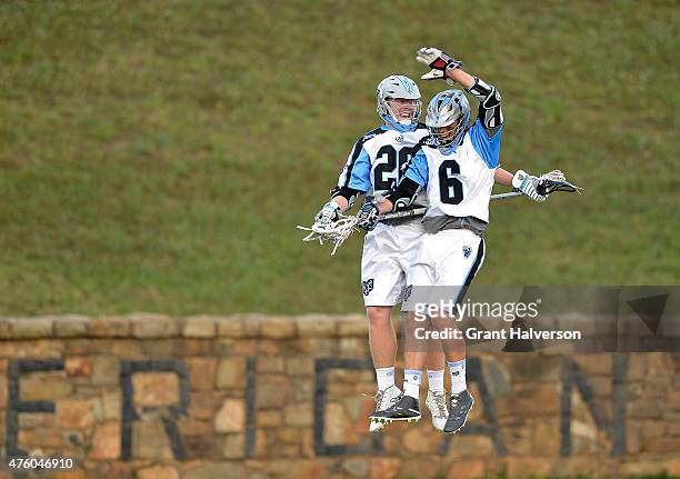 Tom Schreiber celebrates with teammate Steele Stanwick of the Ohio Machine after scoring a goal against the Charlotte Hounds during their game at...