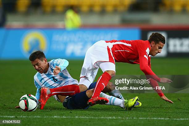 Tiago Casasola of Argentina is challenged by Francesco Lovric of Austria during the FIFA U-20 World Cup New Zealand 2015 Group B match between...