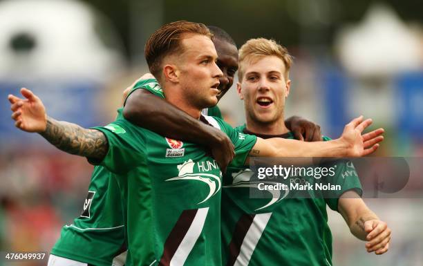 Adam Taggart of the Jets celebrates scoring a goal with team mates Emile Heskey and Andrew Hoole during the round 21 A-League match between the...