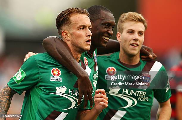 Adam Taggart of the Jets celebrates scoring a goal with team mates Emile Heskey and Andrew Hoole during the round 21 A-League match between the...