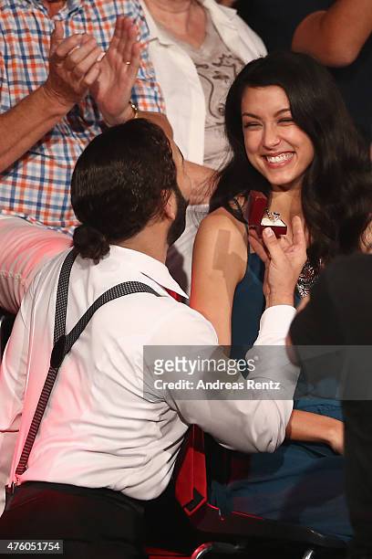 Massimo Sinato presents a marriage proposal to Rebecca Mir during the final show of the television competition 'Let's Dance' on June 5, 2015 in...