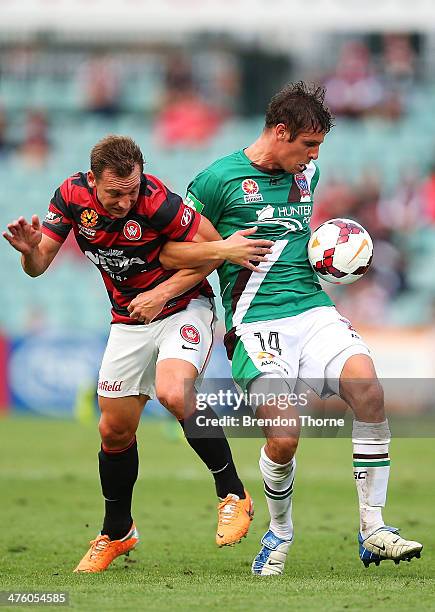 Josh Mitchell of the Jets competes with Brendon Santalab of the Wanderers during the round 21 A-League match between the Western Sydney Wanderers and...