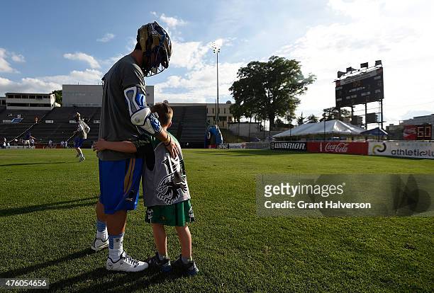 Young fan greets Joey Sankey of the Charlotte Hounds as he warms up before their game against the Ohio Machine at American Legion Memorial Stadium on...