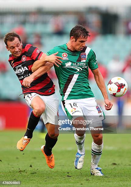 Josh Mitchell of the Jets competes with Brendon Santalab of the Wanderers during the round 21 A-League match between the Western Sydney Wanderers and...