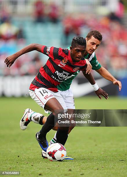 Kwabena Appiah of the Wanderers competes with James Virgili of the Jets during the round 21 A-League match between the Western Sydney Wanderers and...