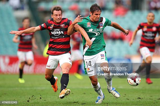 Josh Mitchell of the Jets competes with Brendon Santalab of the Wanderers during the round 21 A-League match between the Western Sydney Wanderers and...