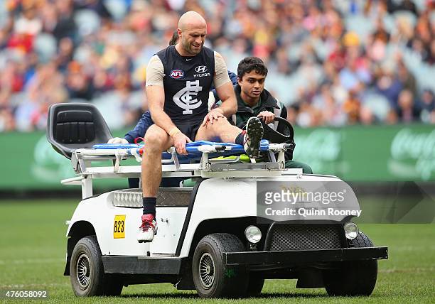 Chris Judd of the Blues is stretchered from the ground after injuring his knee during the round 10 AFL match between the Carlton Blues and the...