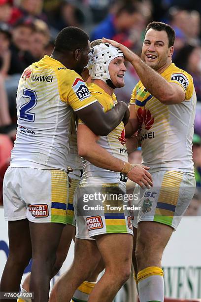 Jarrod Croker Edrick Lee and David Shillington of the Raiders celebrate a try during the round 13 NRL match between the Newcastle Knights and...