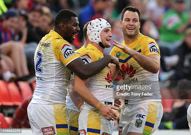 Jarrod Croker Edrick Lee and David Shillington of the Raiders celebrate a try during the round 13 NRL match between the Newcastle Knights and...