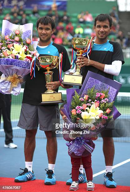 Sonchat Ratiwatana of Thailand with daughter and Sanchat Ratiwatana of Thailand with their trophy after winning their Doubles final match against...