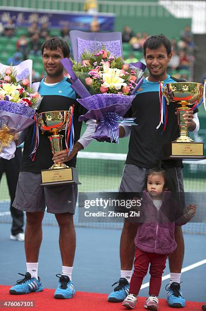 Sonchat Ratiwatana of Thailand with daughter and Sanchat Ratiwatana of Thailand with their trophy after winning their Doubles final match against...