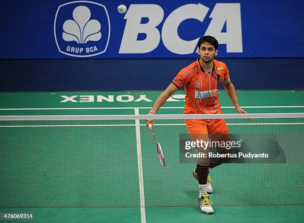 Parupalli Kashyap of India plays a shot against Kento Momota of Japan during the 2015 BCA Indonesia Open Semifinals match at Istora Senayan on June...