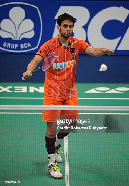 Parupalli Kashyap of India plays a shot against Kento Momota of Japan during the 2015 BCA Indonesia Open Semifinals match at Istora Senayan on June...