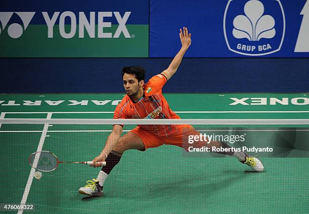 Parupalli Kashyap of India plays a shot against Kento Momota of Japan during the 2015 BCA Indonesia Open Semifinals match at Istora Senayan on June...