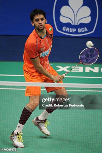 Parupalli Kashyap of India plays a shot against Kento Momota of Japan during the 2015 BCA Indonesia Open Semifinals match at Istora Senayan on June...