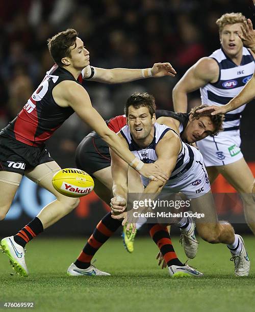 Jared Rivers of the Cats handballs during the round 10 AFL match between the Essendon Bombers and the Geelong Cats at Etihad Stadium on June 6, 2015...