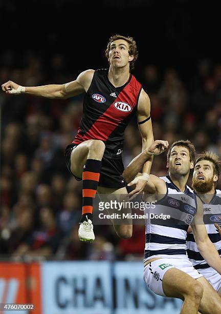 Joe Daniher of the Bombers competes for the ball over Jared Rivers of the Cats during the round 10 AFL match between the Essendon Bombers and the...