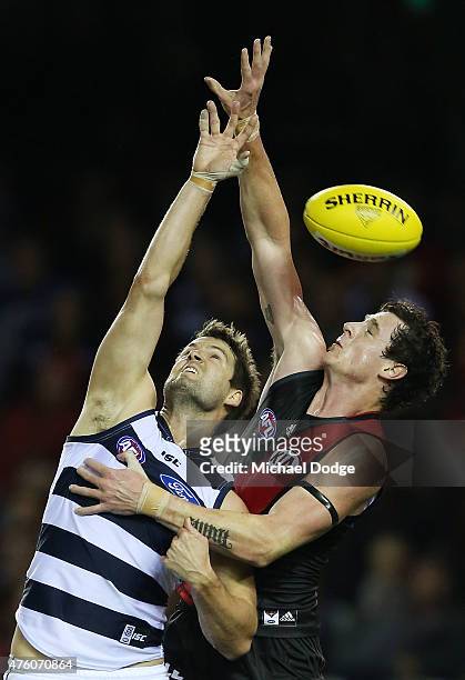 Jake Carlisle of the Bombers competes for the ball against Jared Rivers of the Cats during the round 10 AFL match between the Essendon Bombers and...