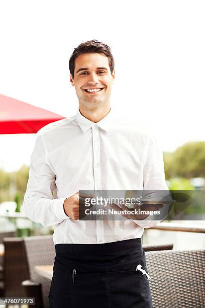happy waiter holding serving tray in restaurant - serving tray 個照片及圖片檔